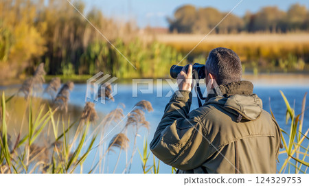 Birdwatching expedition in a tranquil wetland at dawn with wildlife enthusiasts. Generative AI 124329753