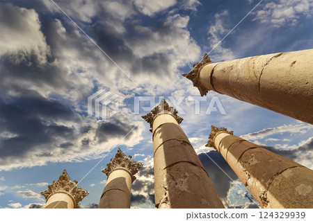 Roman Columns in the Jordanian city of Jerash (Gerasa of Antiquity), capital and largest city of Jerash Governorate, Jordan. Against the background of a beautiful sky with clouds Roman Columns in the Jordanian city of Jerash (Gerasa of Antiquity), capital and largest city of Jerash Governorate, Jordan. Against the background of a beautiful sky with clouds 124329939