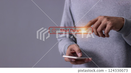 Young man with smartphone hand touching Shut Down button press power OFF Young man with smartphone hand touching Shut Down button press power OFF 124330073