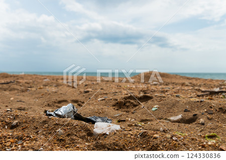Plastic bottles on the sandy beach. Environmental pollution Plastic bottles on the sandy beach. Environmental pollution 124330836