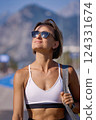 A young girl in sportswear is going to workout with a fitness mat 124331674