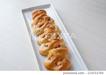 Bacon epi on a white plate 124332784