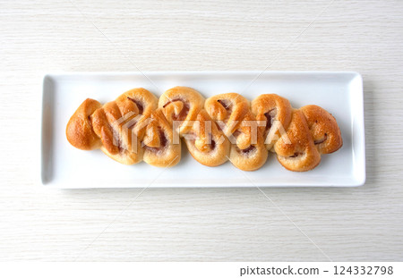 Bacon epi on a white plate Bacon epi on a white plate 124332798