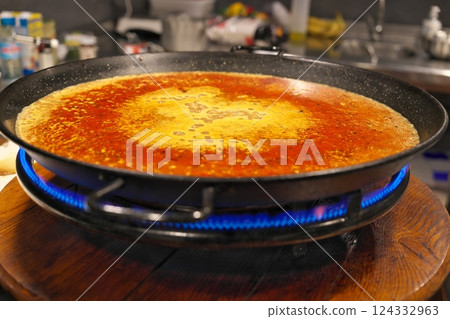 Paella being cooked 124332963