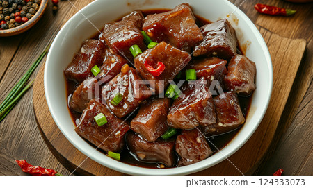 Delicious chinese-style braised beef belly garnished with chilies and green onions 124333073