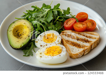 healthy breakfast, greens, tomatoes, boiled egg, avocado and grilled bread 124333488