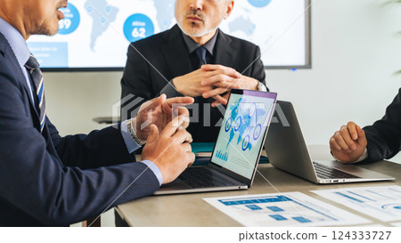 A group of middle-aged male business people meeting in a conference room 124333727
