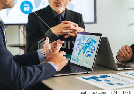 A group of middle-aged male business people meeting in a conference room 124333728