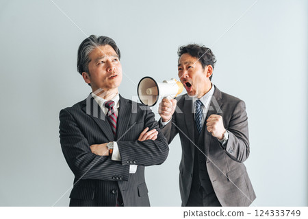 A middle-aged male business person calling out to middle-aged and elderly men through a loudspeaker A middle-aged male business person calling out to middle-aged and elderly men through a loudspeaker 124333749