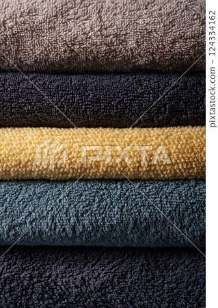 A set of colored terry towels. A stack of beautifully folded towels.Home comfort. 124334162
