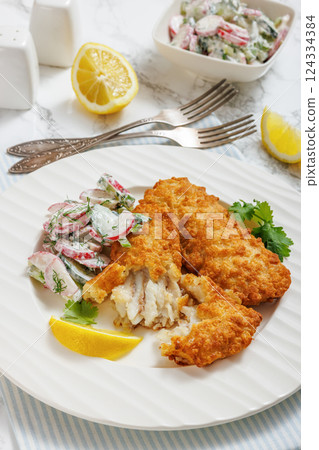 fried battered fish fillets with radish dill salad fried battered fish fillets with radish dill salad 124334384