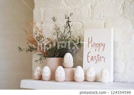 Mantelpiece Easter decoration. White mantel with white Easter eggs, dry flowers, sign Happy Easte.r Mantelpiece Easter decoration. White mantel with white Easter eggs, dry flowers, sign Happy Easte.r 124334599