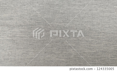 Close-up of textile canvas fabric texture, rough finish, grey color tone for background design. Close-up of textile canvas fabric texture, rough finish, grey color tone for background design. 124335005