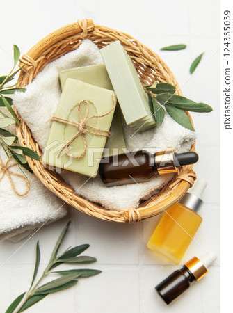 Natural olive soap and essential oil creating relaxing spa atmosphere Natural olive soap and essential oil creating relaxing spa atmosphere 124335039