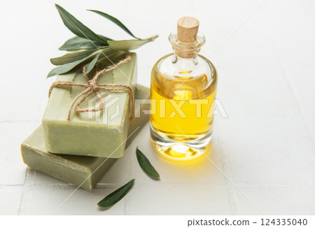 Natural olive soap bars and essential oil promoting wellness and skincare Natural olive soap bars and essential oil promoting wellness and skincare 124335040