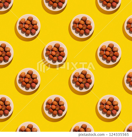 Lychee fruit on bright yellow background, lychee on the plate pattern. Lychee fruit on bright yellow background, lychee on the plate pattern. 124335565