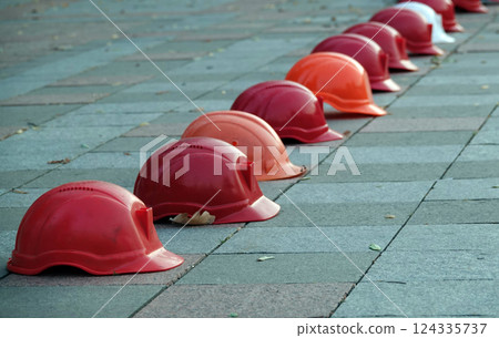 Kiev, Ukraine September 26, 2020: Workers' helmets lined up in a square in protest Kiev, Ukraine September 26, 2020: Workers' helmets lined up in a square in protest 124335737