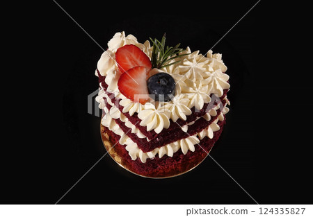 Berry heart cake with cream on a black background - sweets for children and adults Berry heart cake with cream on a black background - sweets for children and adults 124335827