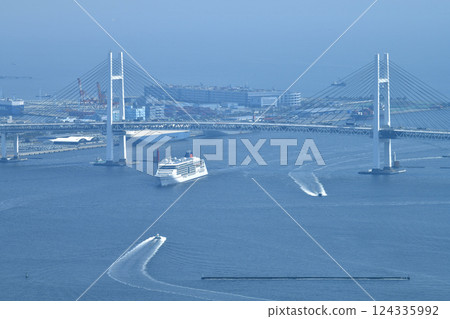 Yokohama cityscape in Japan. First arrival at port. Europa II passing over Yokohama Bay Bridge on March 25th. Yokohama cityscape in Japan. First arrival at port. Europa II passing over Yokohama Bay Bridge on March 25th. 124335992