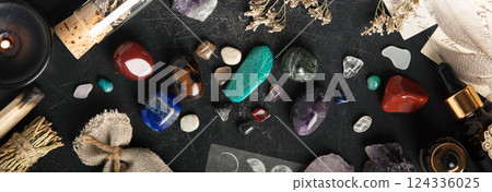 Mystical Flat Lay of Sage, Crystals, and Dried Herbs on Dark Surface banner 124336025