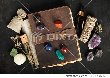 Rustic Leather Journal with Healing Crystals on Dark Background 124336028