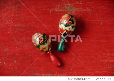 Couple of maracas on vintage red background top view 124336047