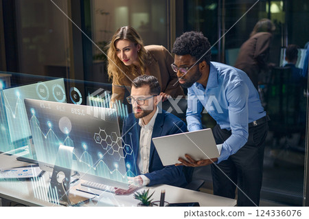 Diverse Team Collaborating on Business Analytics with Digital Visualization in Modern Office 124336076