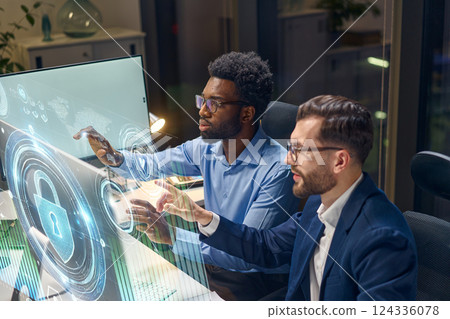 Innovative Team Collaborating on Cybersecurity Solutions with Futuristic Digital Interface Innovative Team Collaborating on Cybersecurity Solutions with Futuristic Digital Interface 124336078