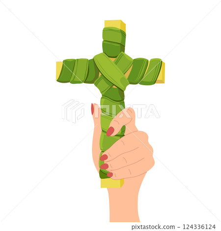 A hand holds a green palm leaf crucifix for the celebration of Palm Sunday, a symbol of the Christian holiday before Easter. 124336124