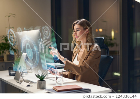 Young Professional Working With Holographic Interface in a Modern Office Environment 124336144