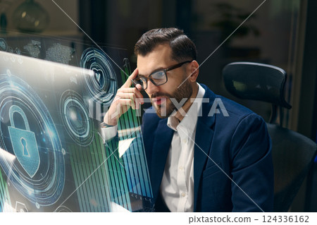 Professional Analyzing Cybersecurity Interface on High-Tech Screen in modern Workspace Professional Analyzing Cybersecurity Interface on High-Tech Screen in modern Workspace 124336162