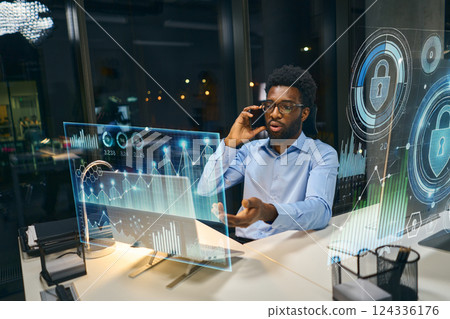 Business Professional Discussing Digital Analytics and Cybersecurity in Futuristic Office Business Professional Discussing Digital Analytics and Cybersecurity in Futuristic Office 124336176