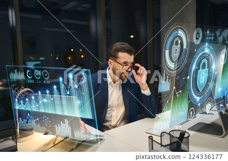 Professional Analyzing Cybersecurity Data on Futuristic Digital Screens in Modern Office Professional Analyzing Cybersecurity Data on Futuristic Digital Screens in Modern Office 124336177