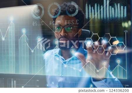 Businessman Analyzing Interactive Data Visualizations on Advanced Digital Interface Screen 124336200