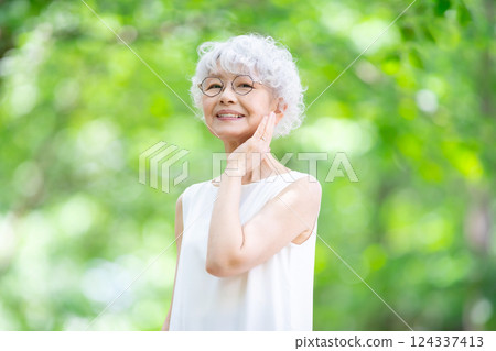 Gray-haired woman, fresh greenery 124337413