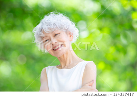Gray-haired woman, fresh greenery Gray-haired woman, fresh greenery 124337417