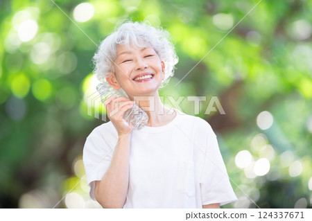 Gray-haired woman, fresh greenery, hydration Gray-haired woman, fresh greenery, hydration 124337671