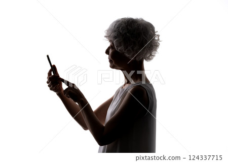 Senior woman silhouette smartphone Senior woman silhouette smartphone 124337715
