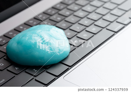 Blue gel slug on black keyboard 124337939