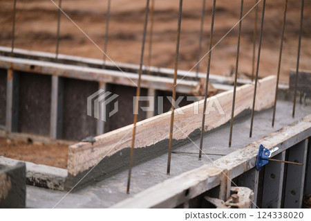 Construction of pile-grillage foundation. Monolithic foundation with metal reinforcement. Monolithic concrete foundation. House construction 124338020