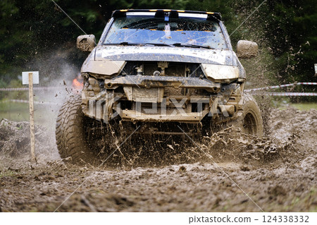 Offroad sport for racing, speed, show and entertainment. Interesting images from offroad races on challenging tracks created among pine trees. 124338332