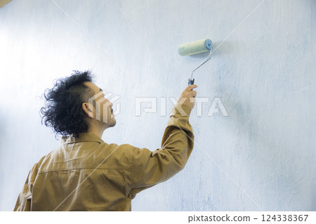 A man in overalls painting A man in overalls painting 124338367