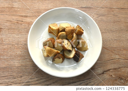slice grilled king oyster mushroom or Enoki dressing salt and black pepper on plate slice grilled king oyster mushroom or Enoki dressing salt and black pepper on plate 124338775