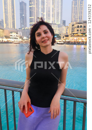 Evening portrait of a woman 40-44 years old against the backdrop of city lights Evening portrait of a woman 40-44 years old against the backdrop of city lights 124339252