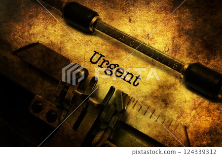 Urgent text on vintage typewriter 124339312