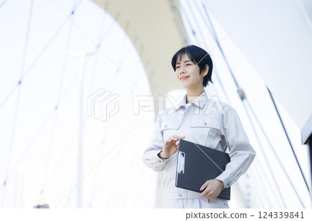 Woman in work clothes at a construction site 124339841