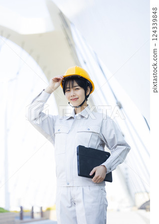 Woman in work clothes at a construction site 124339848