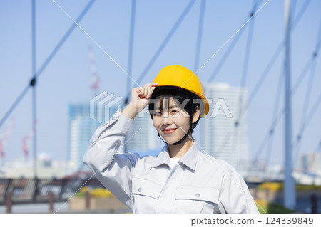 Woman in work clothes at a construction site 124339849