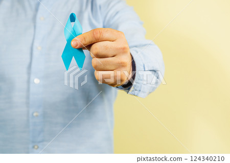 Raising awareness for cancer with a blue ribbon for men's health initiatives 124340210