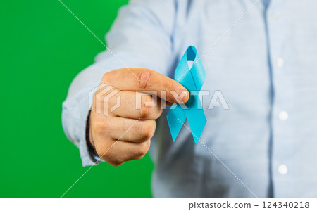 Raising awareness for male health issues with a blue ribbon 124340218